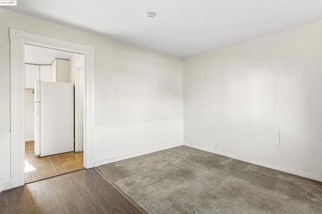 unfurnished room featuring light carpet