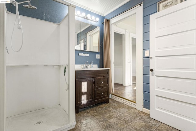 bathroom with crown molding, a shower, and vanity