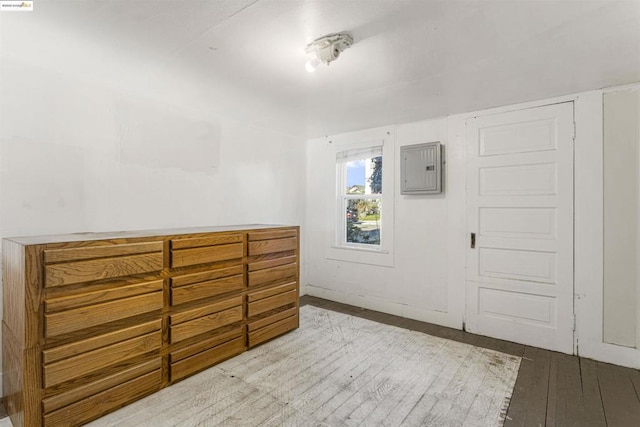 interior space featuring electric panel and light hardwood / wood-style floors