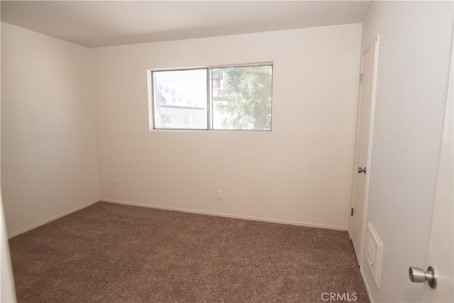 carpeted empty room with baseboards