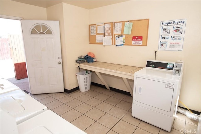 community laundry room with light tile patterned floors and washer and dryer