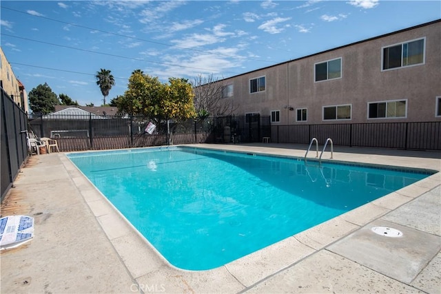 pool featuring a patio and fence