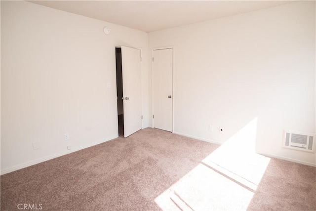 carpeted spare room featuring visible vents