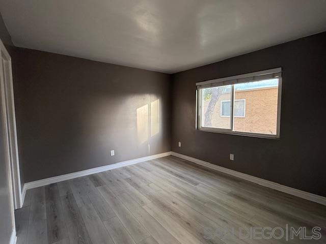 empty room featuring wood-type flooring