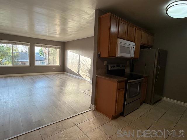 kitchen with light tile patterned floors and appliances with stainless steel finishes