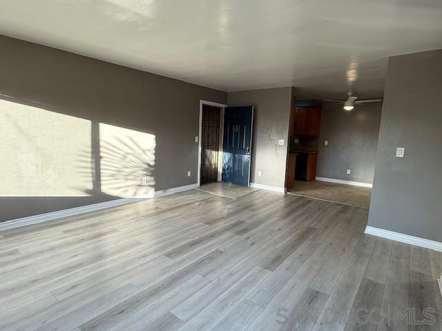 unfurnished living room with light wood-type flooring and ceiling fan