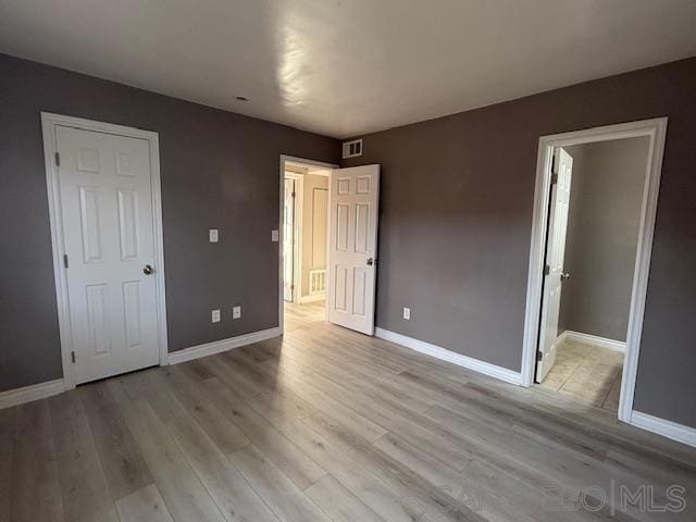 unfurnished bedroom featuring light wood-type flooring