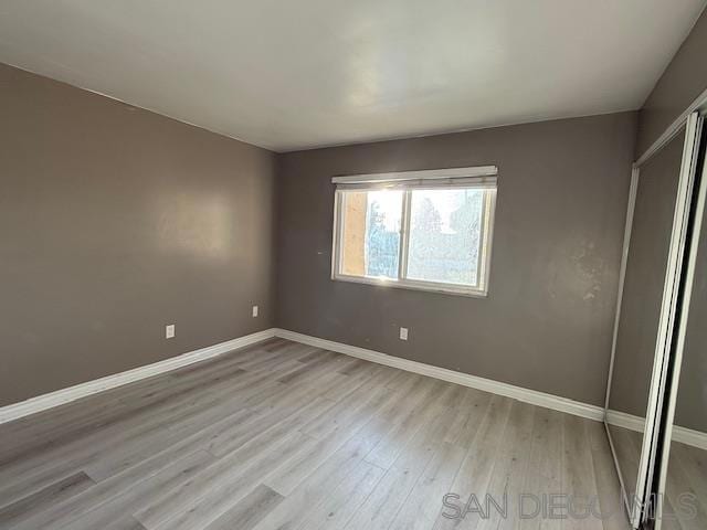 empty room with light hardwood / wood-style floors