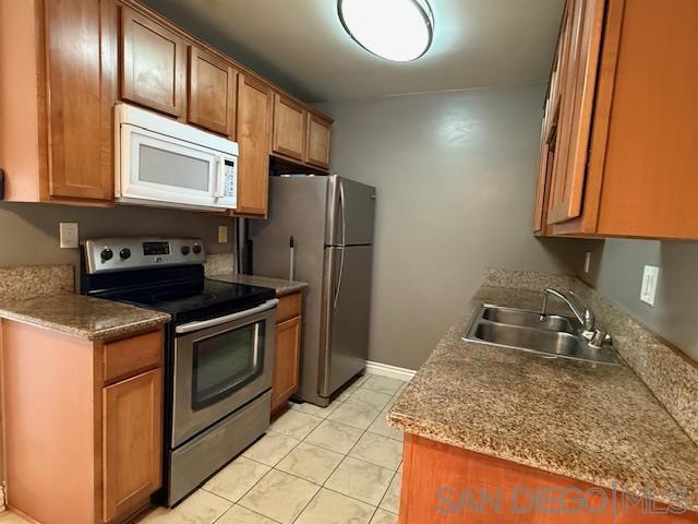 kitchen featuring light tile patterned floors, sink, and appliances with stainless steel finishes