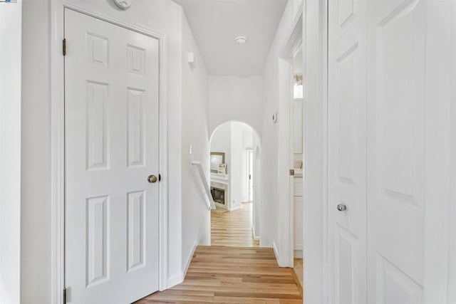 hallway with light hardwood / wood-style flooring