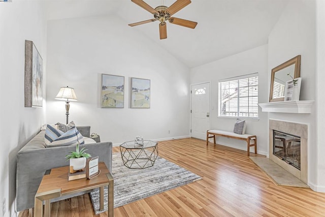 living room with ceiling fan, hardwood / wood-style floors, and high vaulted ceiling