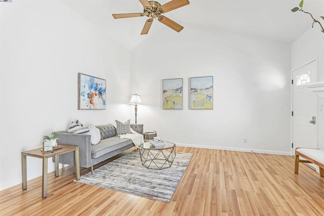 living room with light wood-type flooring, ceiling fan, and high vaulted ceiling