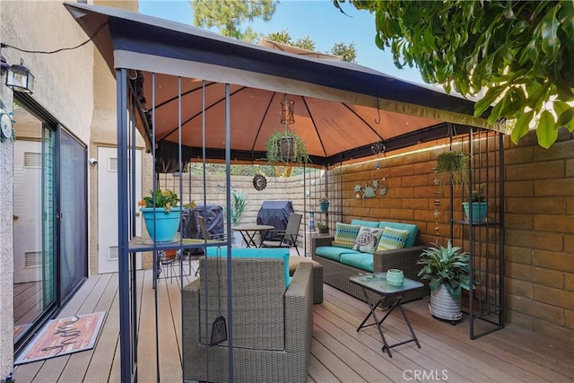 wooden deck with a gazebo and an outdoor hangout area