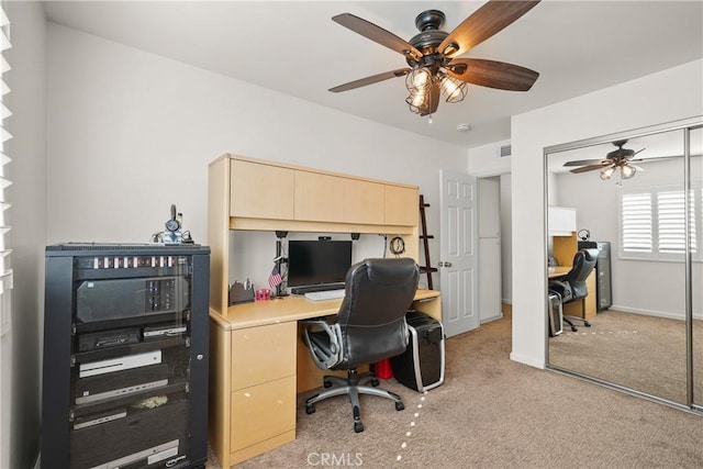 home office featuring light colored carpet and ceiling fan