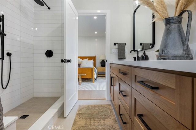 bathroom with vanity and tiled shower