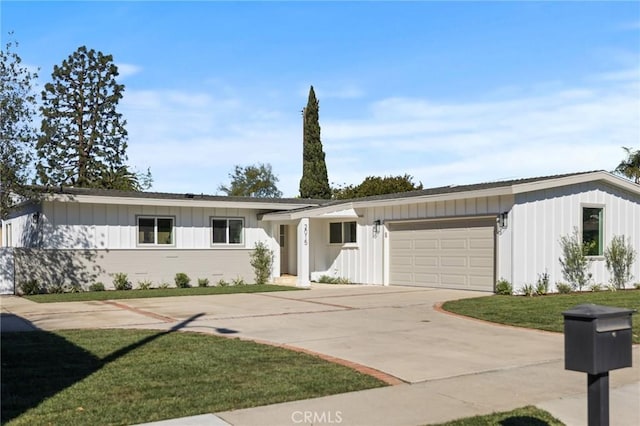 view of front of property with a garage and a front yard