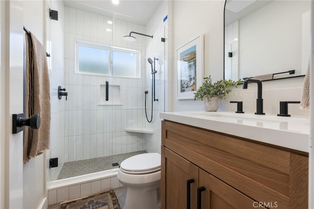 bathroom with vanity, an enclosed shower, and toilet