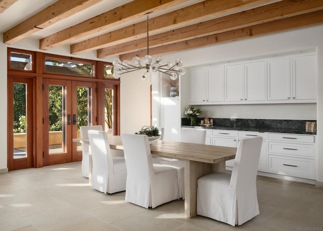 dining room featuring an inviting chandelier, french doors, and beamed ceiling