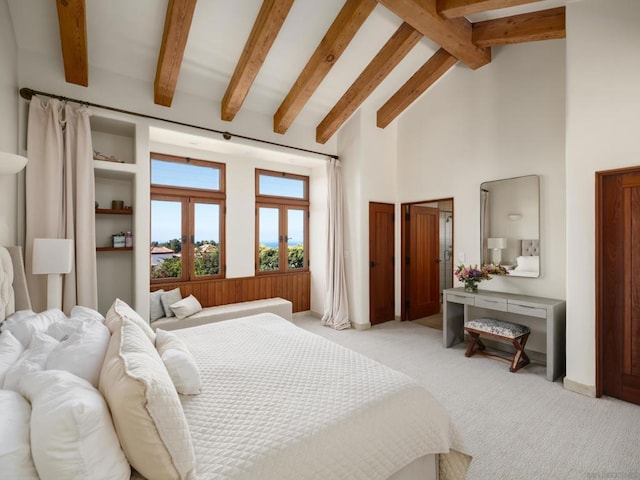 bedroom with beam ceiling, light colored carpet, and high vaulted ceiling