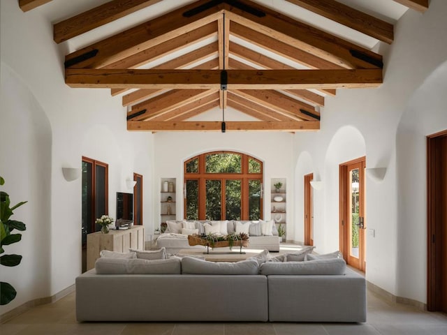 living room featuring beam ceiling, a wealth of natural light, and high vaulted ceiling