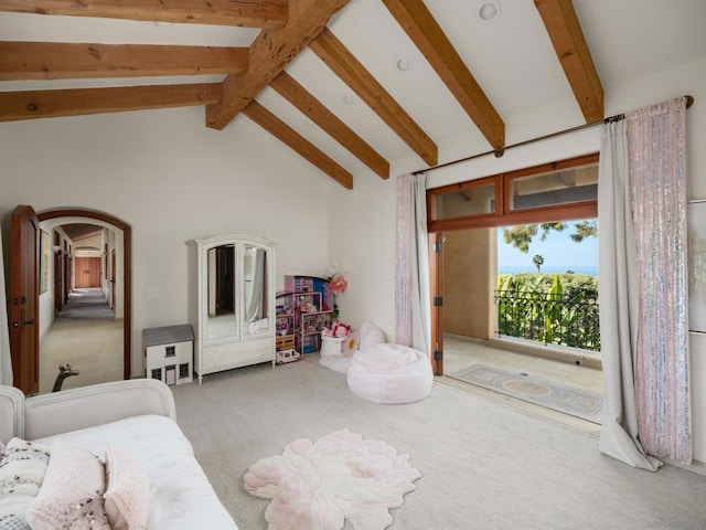 carpeted bedroom featuring access to outside and vaulted ceiling with beams