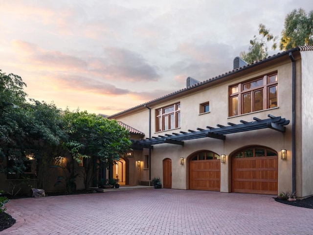 mediterranean / spanish house featuring a garage