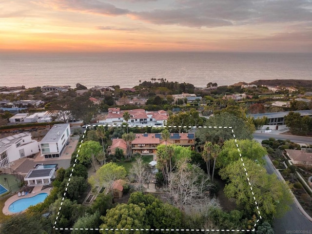 aerial view at dusk with a water view