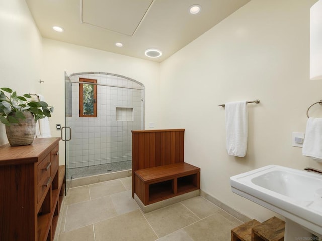 bathroom featuring tile patterned flooring, sink, and walk in shower