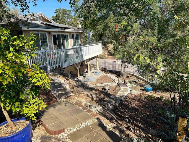 view of yard featuring a deck and a patio area