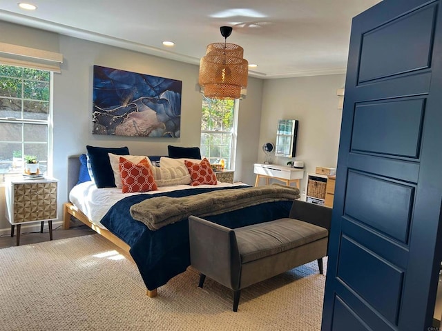 bedroom with ornamental molding and multiple windows