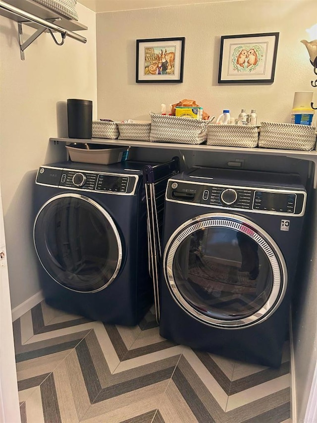 clothes washing area with washing machine and clothes dryer