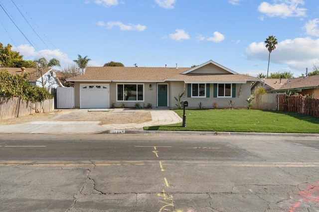 ranch-style house featuring a garage and a front lawn