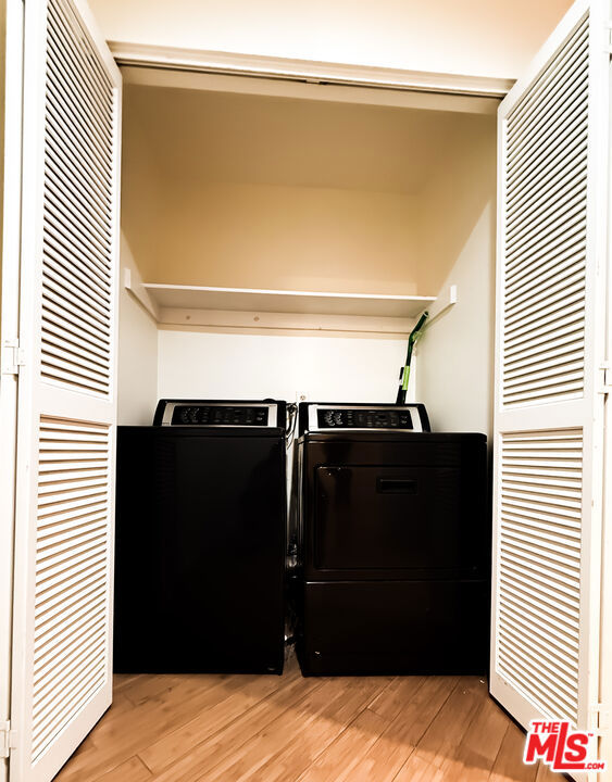 washroom featuring hardwood / wood-style floors and independent washer and dryer