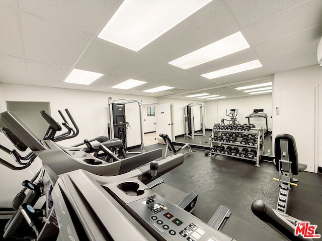 workout area featuring a paneled ceiling