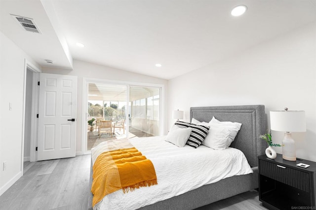 bedroom featuring lofted ceiling, access to outside, and light wood-type flooring