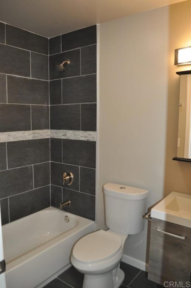 full bathroom featuring vanity, toilet, tile patterned floors, and tiled shower / bath combo