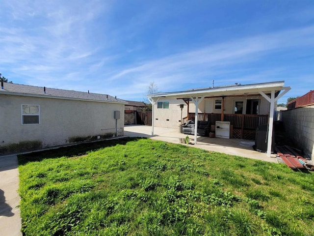 rear view of house with a patio area and a lawn