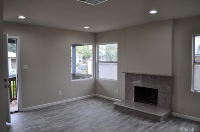 unfurnished living room with a premium fireplace and wood-type flooring