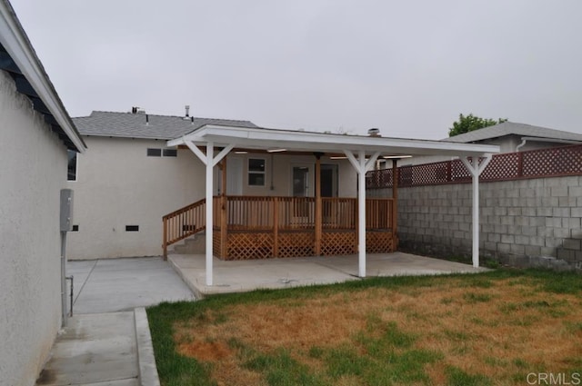 back of house with a patio and a yard