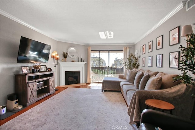 living room featuring crown molding and hardwood / wood-style flooring