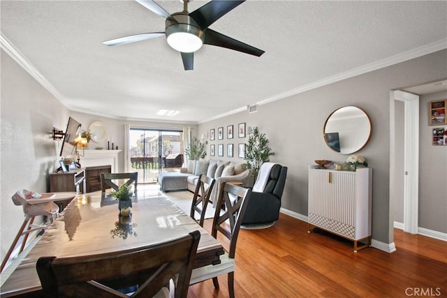 dining space featuring crown molding, hardwood / wood-style floors, and ceiling fan