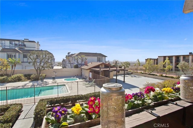 view of pool with a hot tub and a patio