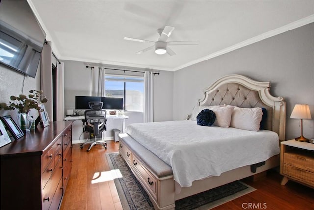 bedroom with hardwood / wood-style flooring, ornamental molding, and ceiling fan