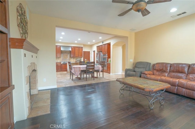 living room featuring ceiling fan and light hardwood / wood-style flooring