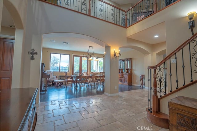 entryway featuring a towering ceiling