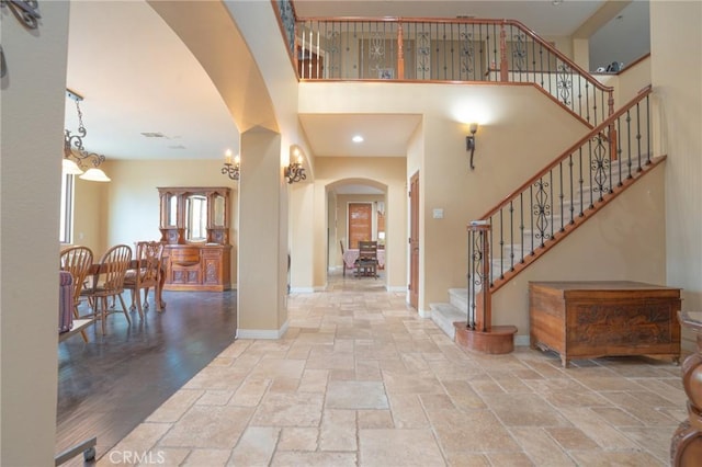 foyer featuring a towering ceiling