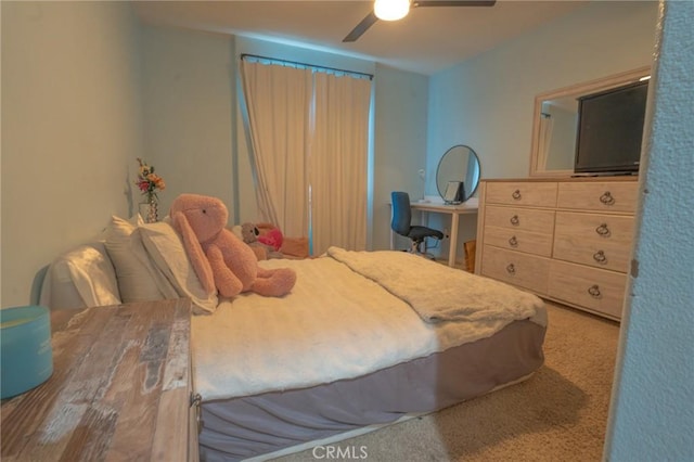 bedroom featuring ceiling fan and carpet