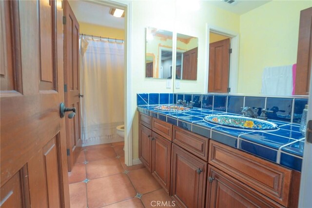 bathroom featuring vanity, tile patterned floors, toilet, and a shower with shower curtain