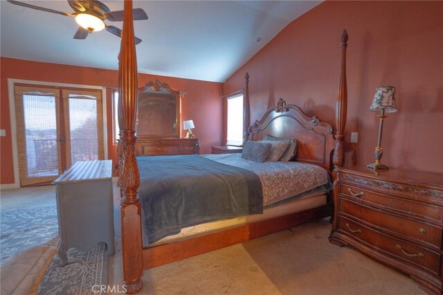 carpeted bedroom with ceiling fan and vaulted ceiling