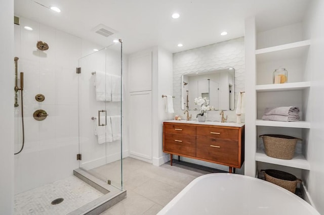 bathroom featuring tile patterned flooring, plus walk in shower, and vanity